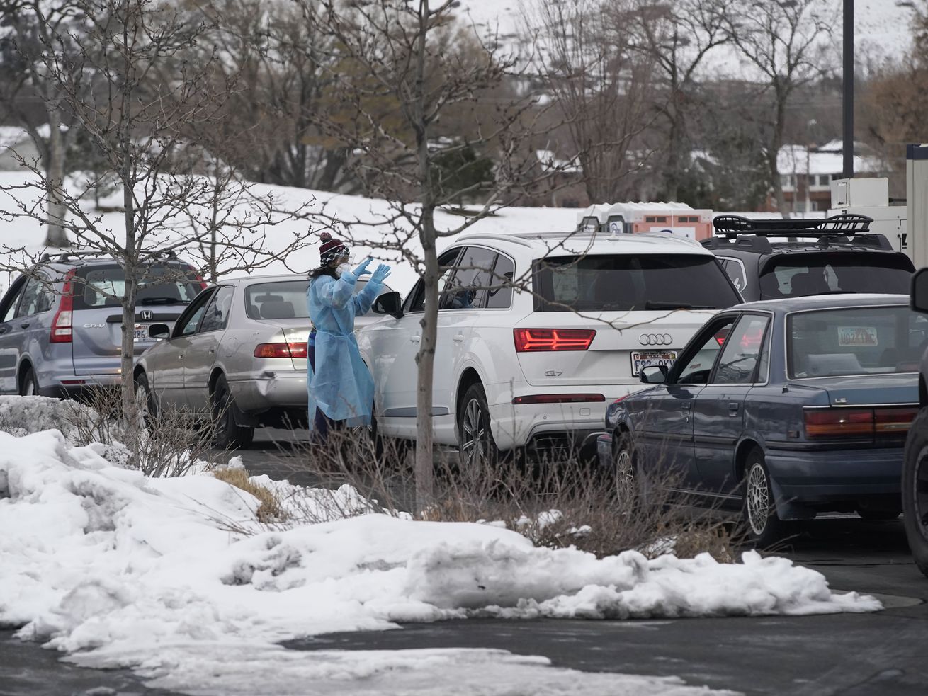 A medical worker attends a passenger at a COVID-19 testing site at the Draper Senior Center on Monday. The Utah Department of Health announced Friday that it's changing the procedures at COVID-19 testing sites due to high demand.