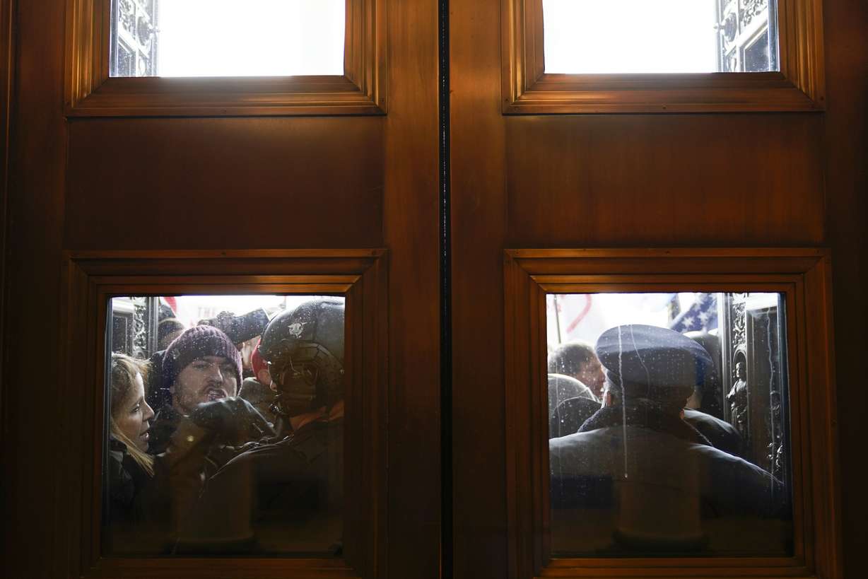 U.S. Capitol Police try to hold back rioters outside the east doors to the House side of the U.S. Capitol, Jan 6, 2021.