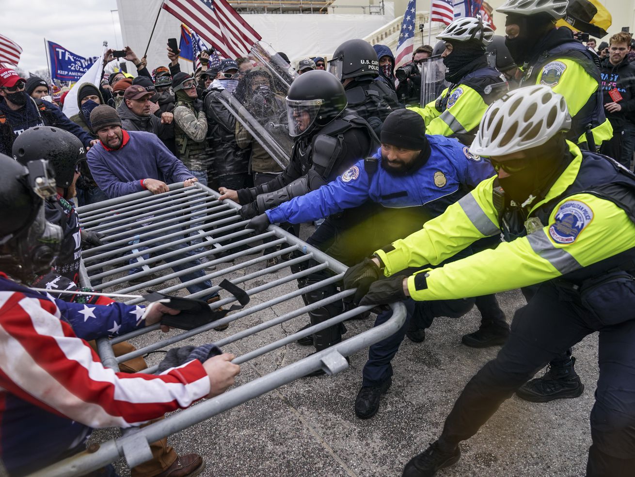 Supporters of President Donald Trump try to break through a police barrier on Wednesday, Jan. 6, 2021, at the Capitol in Washington, D.C.