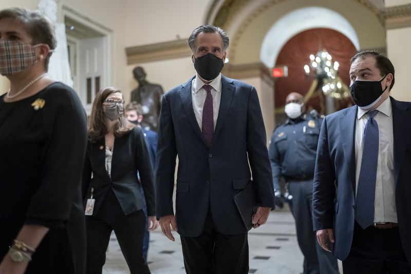 After violent protesters loyal to President Donald
Trump stormed the U.S. Capitol, Sen. Mitt Romney, R-Utah, joins
other senators as they return to the House chamber to continue the
joint session of the House and Senate and count the electoral votes
cast in November’s election at the Capitol in Washington on
Wednesday, Jan. 6, 2021.