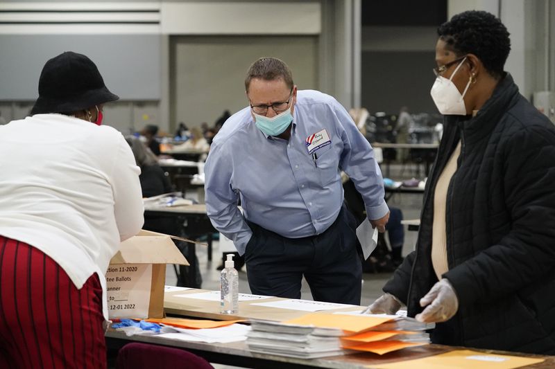 Randy Osborne, Republican party elections observer,
looks as officials sort ballots during an audit at the Georgia
World Congress Center on Saturday, Nov. 14, 2020, in Atlanta.
Election officials in Georgia’s 159 counties are undertaking a hand
tally of the presidential race that stems from an audit required by
state law.