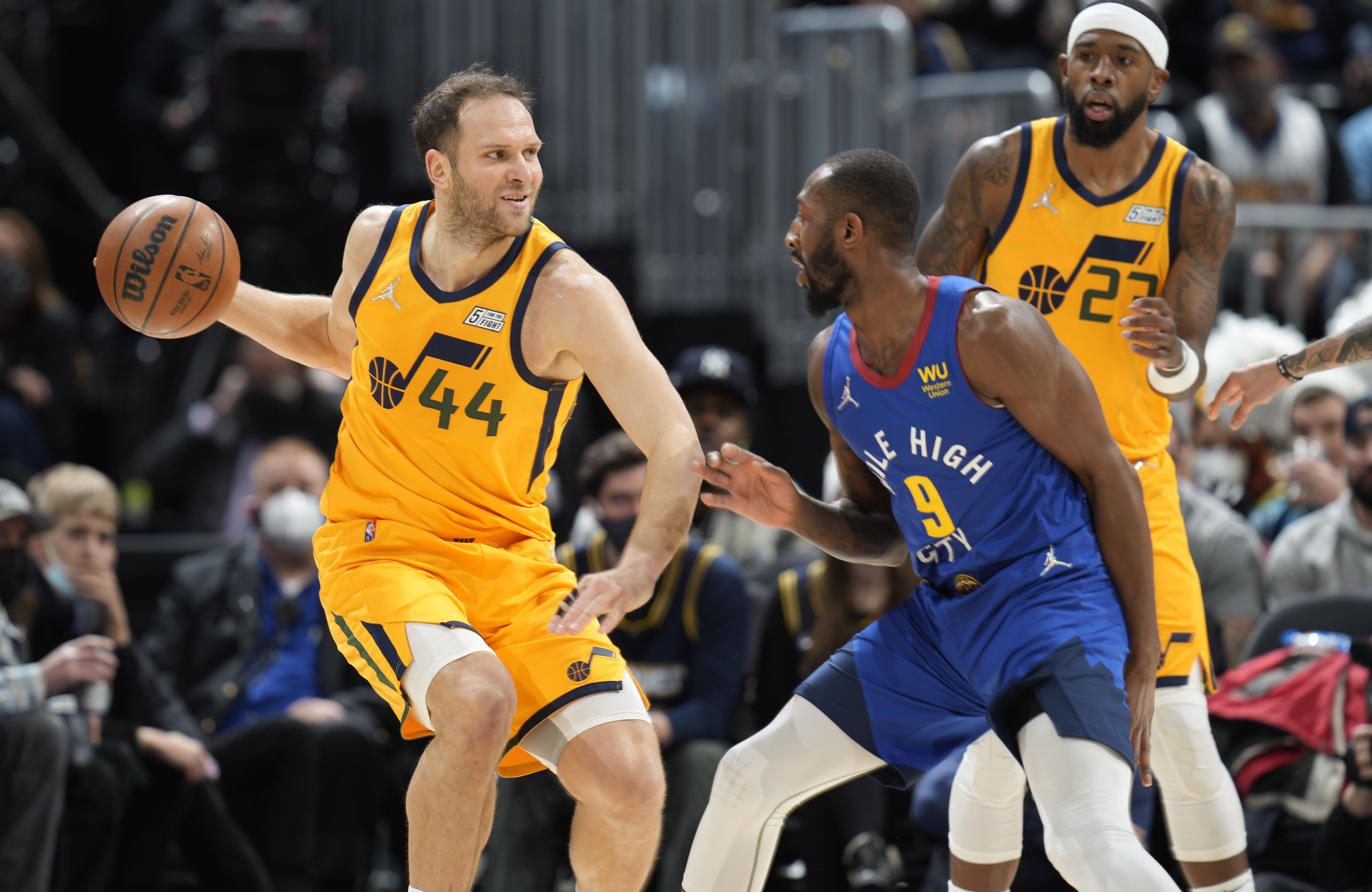 Utah Jazz forward Bojan Bogdanovic, left, looks to pass the ball as Denver Nuggets guard Davon Reed defends in the first half of an NBA basketball game Wednesday, Jan. 5, 2022, in Denver.