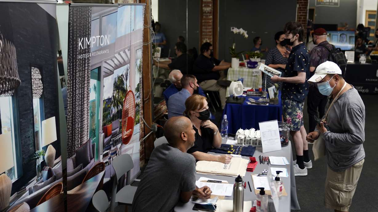 Prospective employers and job seekers interact during during a job fair on Sept. 22, 2021, in Los Angeles. U.S. jobless claims rose by 7,000, the US Department of Labor announced Thursday.