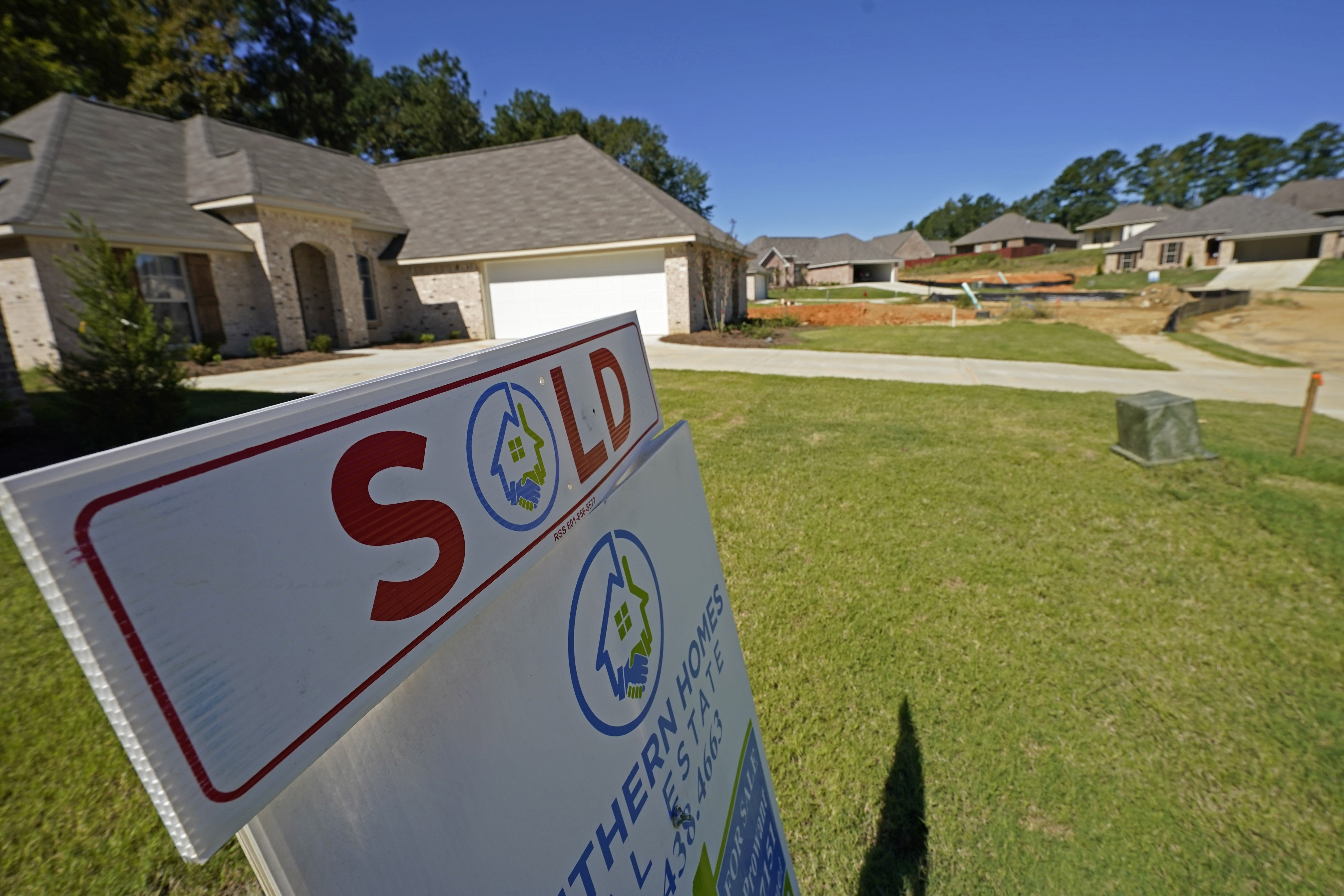 A "Sold" sign is on display at a new house in Pearl, Miss., Sept. 23, 2021. The fierce competition, low mortgage rates and soaring prices that helped raise mortgage borrowing to record heights last year is expected to drive lending even higher in 2022.