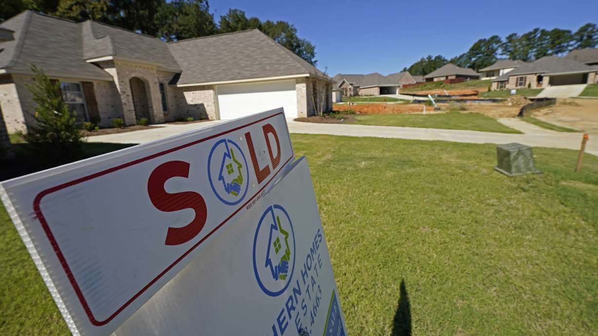 A "Sold" sign is on display at a new house in Pearl, Miss., Sept. 23, 2021. The fierce competition, low mortgage rates and soaring prices that helped raise mortgage borrowing to record heights last year is expected to drive lending even higher in 2022.