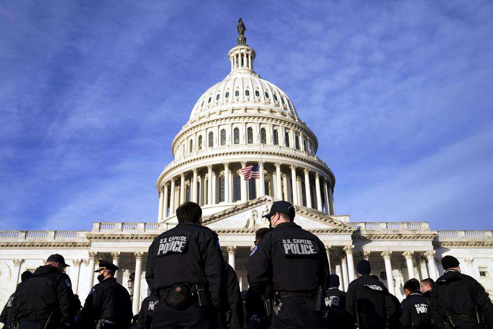 A large group of police arrive at the Capitol, Thursday in Washington. President Joe Biden and members of Congress are solemnly marking the first anniversary of the Jan. 6 U.S. Capitol insurrection. Lawmakers are holding events Thursday to reflect on the violent attack by supporters of then-President Donald Trump. The ceremonies will be widely attended by Democrats, but almost every Republican on Capitol Hill will be absent.