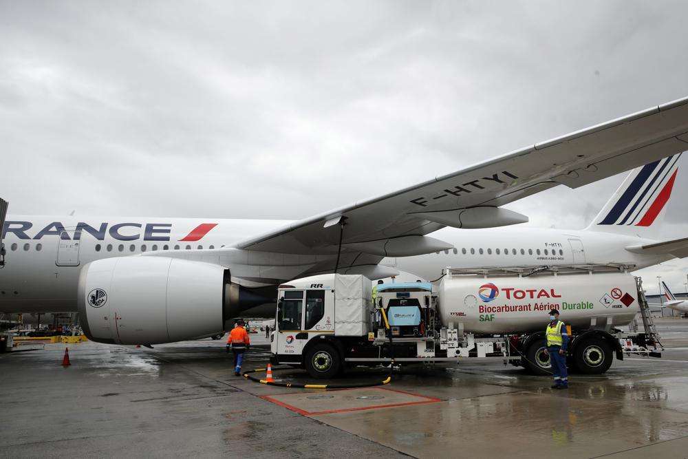 Workers refuel an Airbus A350 at Roissy airport, north of Paris, Tuesday, May 18, 2021. The European Union's airspace is filling up again with near-empty flights in pandemic times that even airlines admit serve no commercial purpose except securing valuable slots in some of the world's biggest airports.