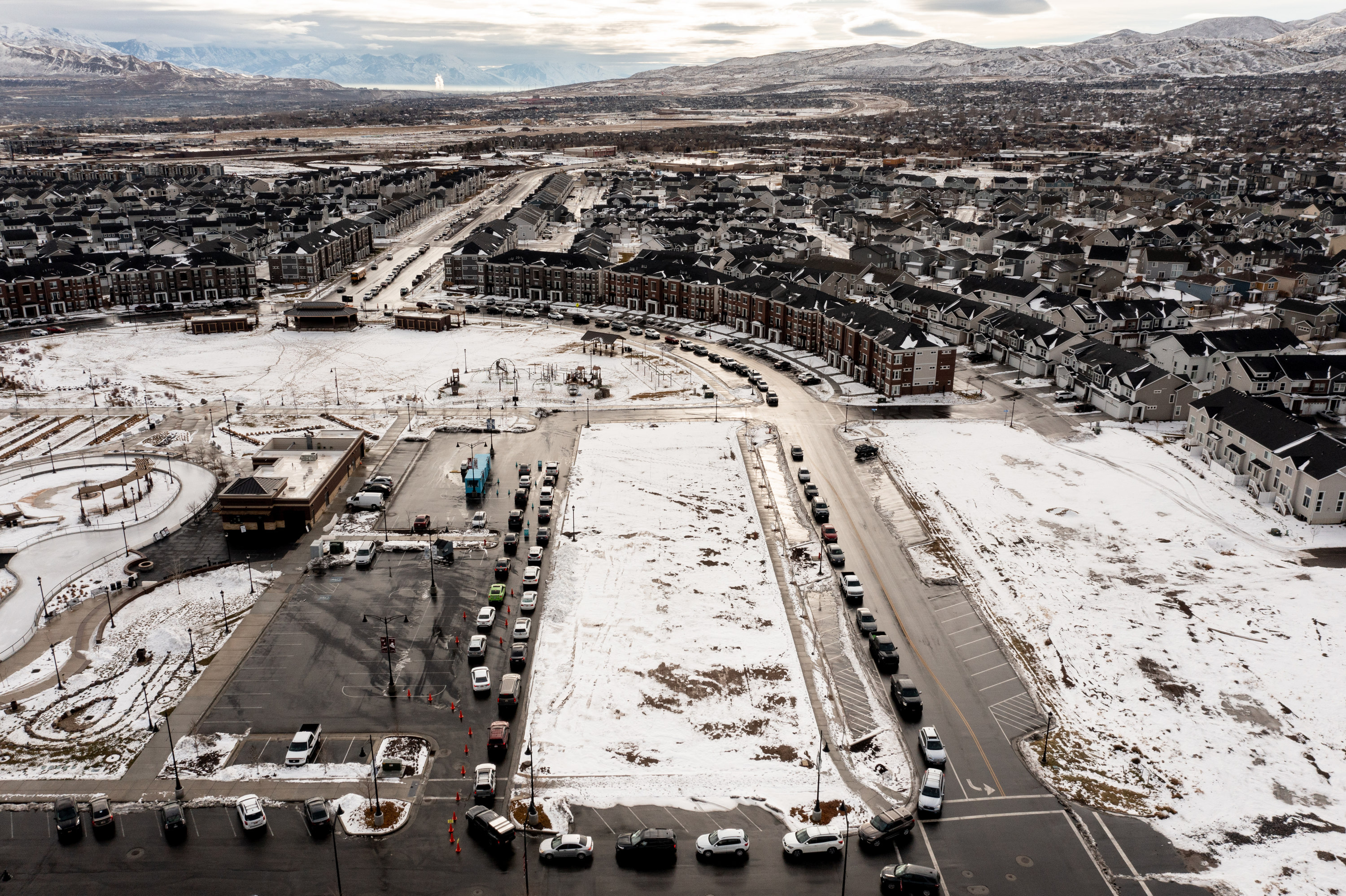 Cars line up as people wait in line for COVID-19 tests at City Hall in Herriman on Thursday. The omicron variant has emerged as the top strain in Utah quickly, according to state data.
