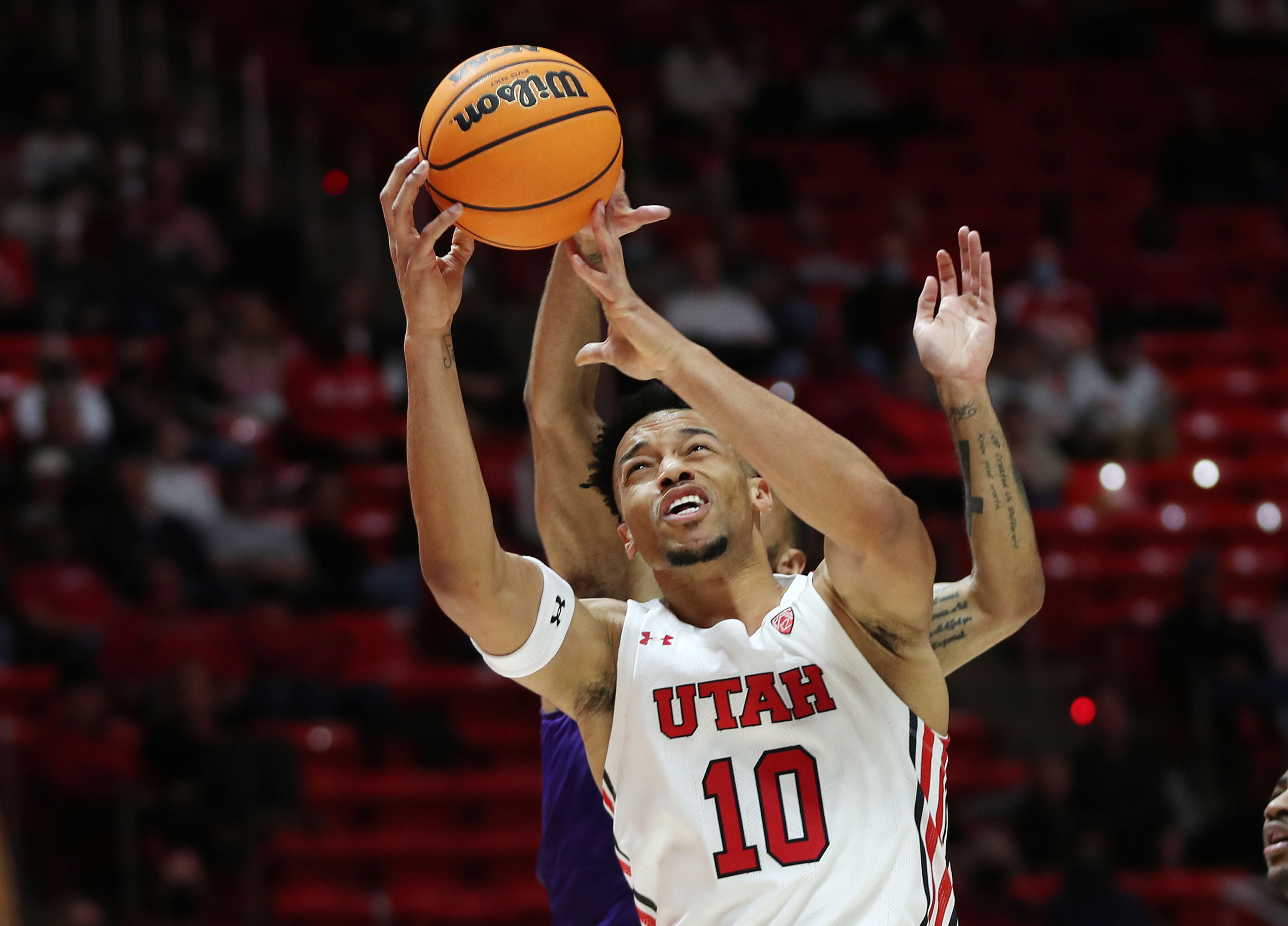Utah Utes guard Marco Anthony (10) drive son the Washington Huskies in Salt Lake City on Thursday, Jan. 6, 2022.