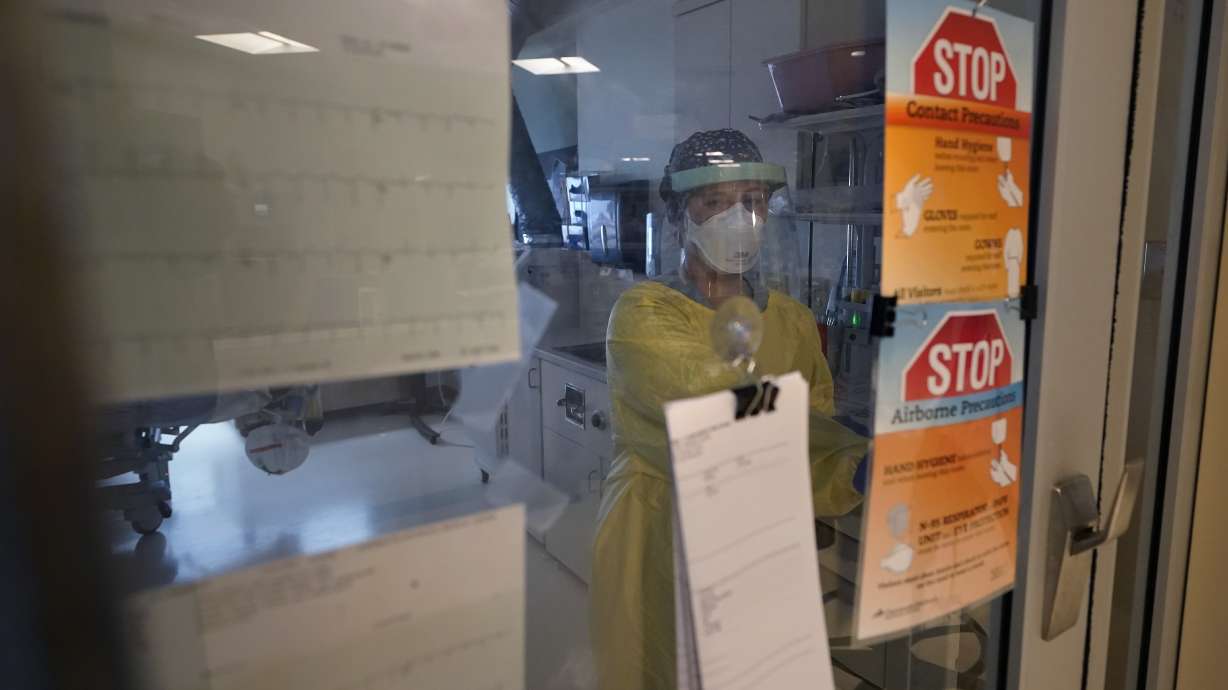 Registered nurse Morgan Flynn works inside a patient's room in the COVID-19 Intensive Care Unit at Dartmouth-Hitchcock Medical Center, in Lebanon, N.H., Monday, Jan. 3. Hospitalizations in U.S. children under age 5 with COVID have soared dramatically to unprecedented levels, a worrisome trend in youngsters too young to be vaccinated.