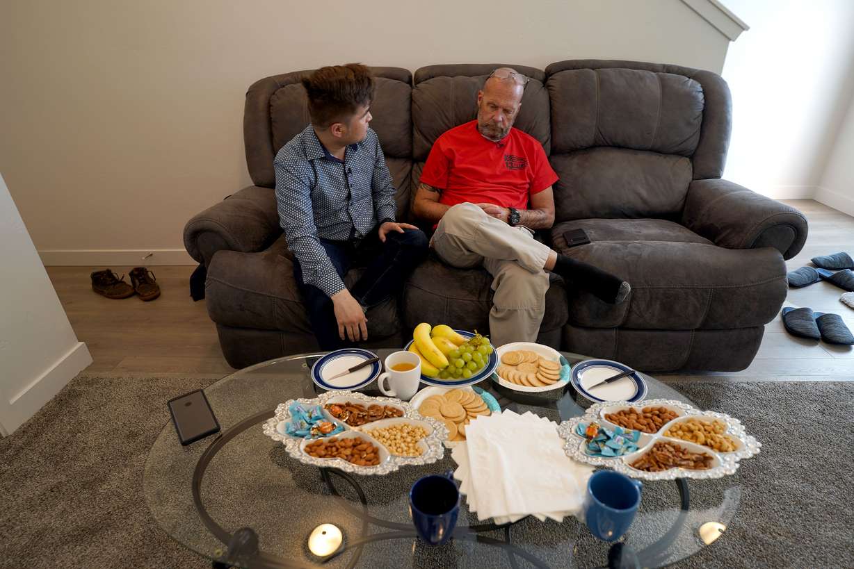 Afghan refugee Azim Kakaie, left, talks with Darin Hoover, right, at Kakaie's house in North Salt Lake on Saturday, Nov. 13, 2021. Hoover's son, Marine Staff Sgt. Taylor Hoover, was killed in a suicide bombing at the airport in Kabul, Afghanistan, on Aug. 26, about 30 minutes after helping Kakaie's family through the gate.
