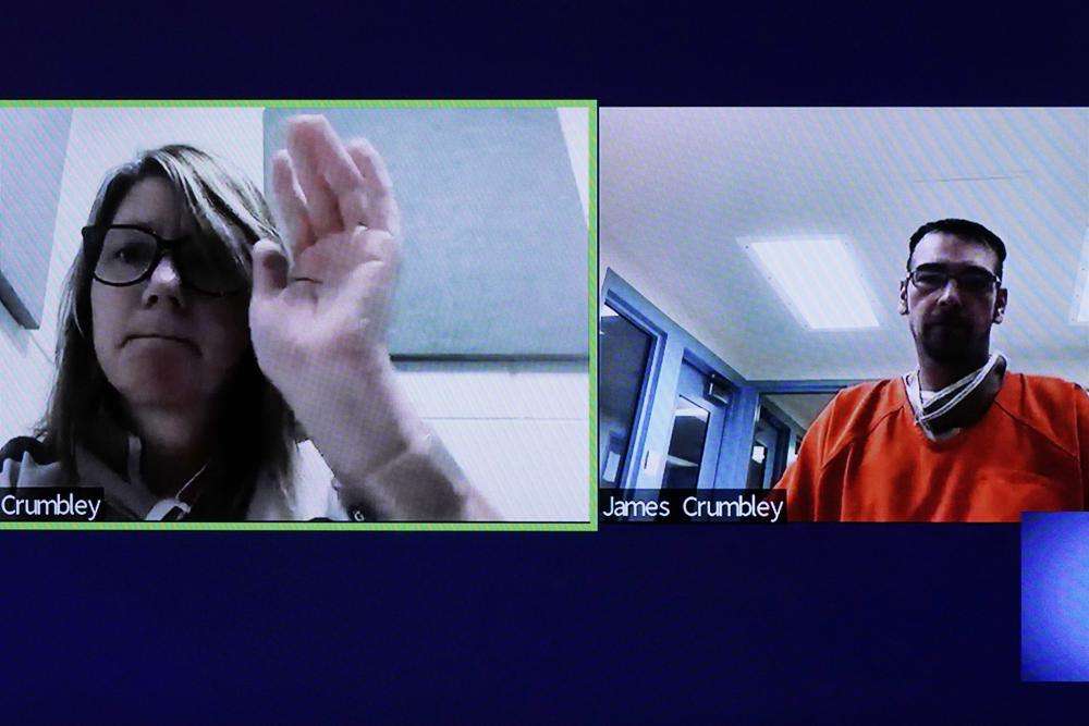 This image from 52-3 District Court shows Jennifer Crumbley waving to her husband James during a Zoom hearing in Rochester Hills, Mich., Friday. The Crumbleys have been in jail since Dec. 4 and are unable to meet the bond. They are charged with involuntary manslaughter in the deaths at Oxford High School on Nov. 30.