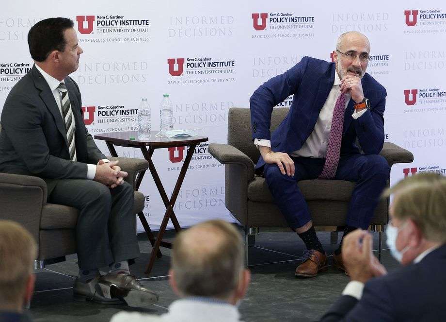 Utah House Speaker Brad Wilson, R-Kaysville, left, listens as Arthur Brooks speaks at the Kem C. Gardner Policy Institute symposium at the Thomas S. Monson Center in Salt Lake City on Friday.