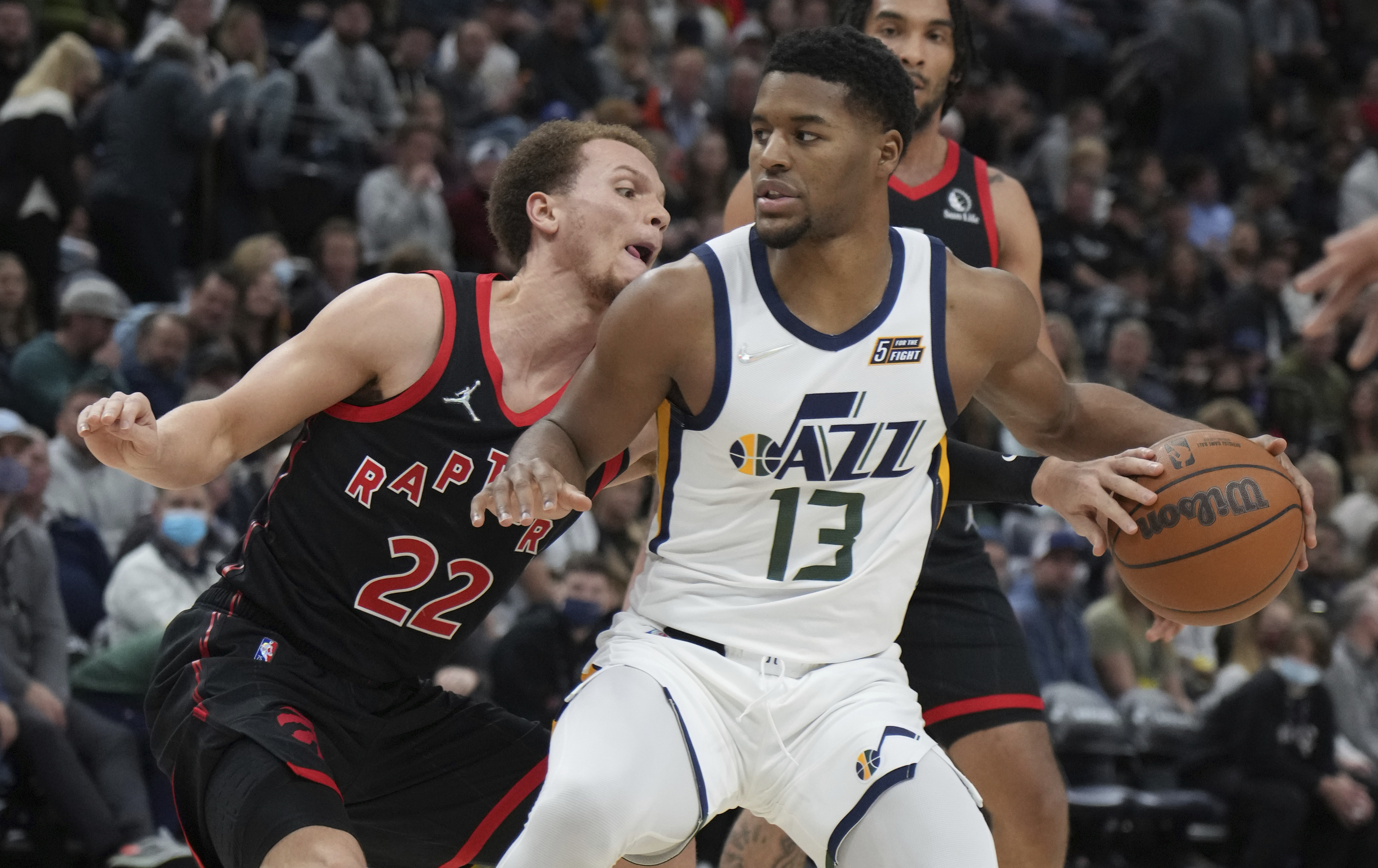 Toronto Raptors guard Malachi Flynn (22) defends against Utah Jazz guard Jared Butler (13) during the first half of an NBA basketball game Thursday, Nov. 18, 2021, in Salt Lake City.