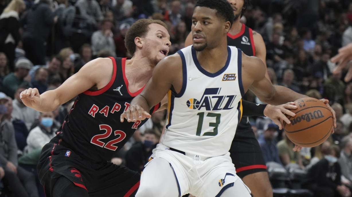 Toronto Raptors guard Malachi Flynn (22) defends against Utah Jazz guard Jared Butler (13) during the first half of an NBA basketball game Thursday, Nov. 18, 2021, in Salt Lake City.