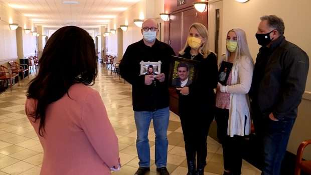 Cory Haney’s family members held photos of him during a court hearing for his alleged killer on Friday.