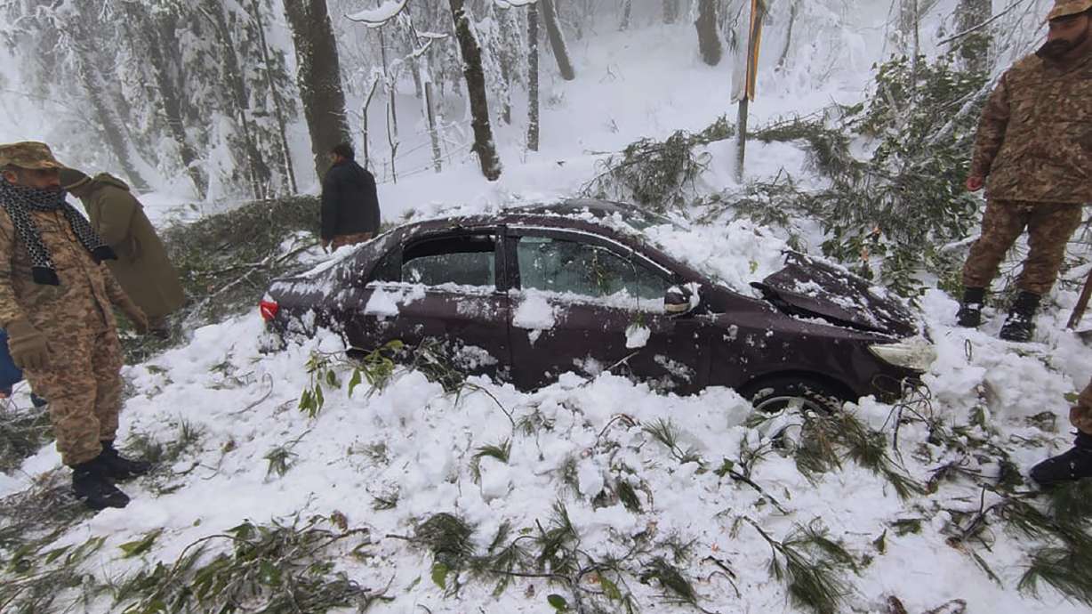 In this photo provided by the Inter Services Public Relations, army troops take part in rescue operation in a heavy snowfall-hit area in Murree, some 28 miles (45 kilometers) north of the capital of Islamabad, Pakistan, Saturday. Temperatures fell to -8 degrees Celsius (17.6 Fahrenheit) amid heavy snowfall at Pakistan's mountain resort town of Murree overnight, killing multiple people who were stuck in their vehicles, officials said Saturday.