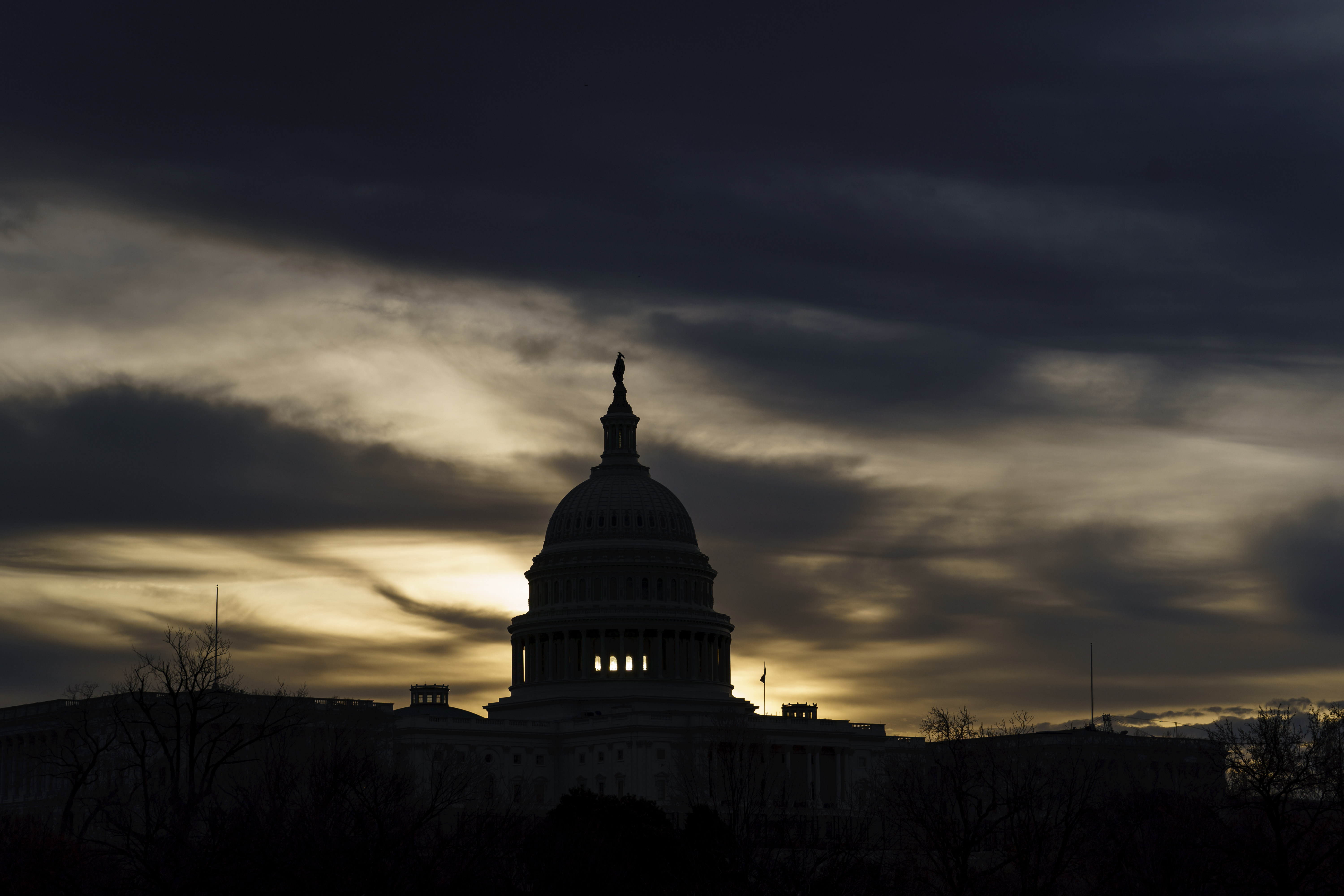 The U.S. Capitol is seen in Washington, early Dec. 17, 2021. President Joe Biden faces a steep path to achieve his ambitious goal to slash planet-warming greenhouse gas emissions in half by 2030, as a $2 trillion package of social and environmental initiatives remains stalled.