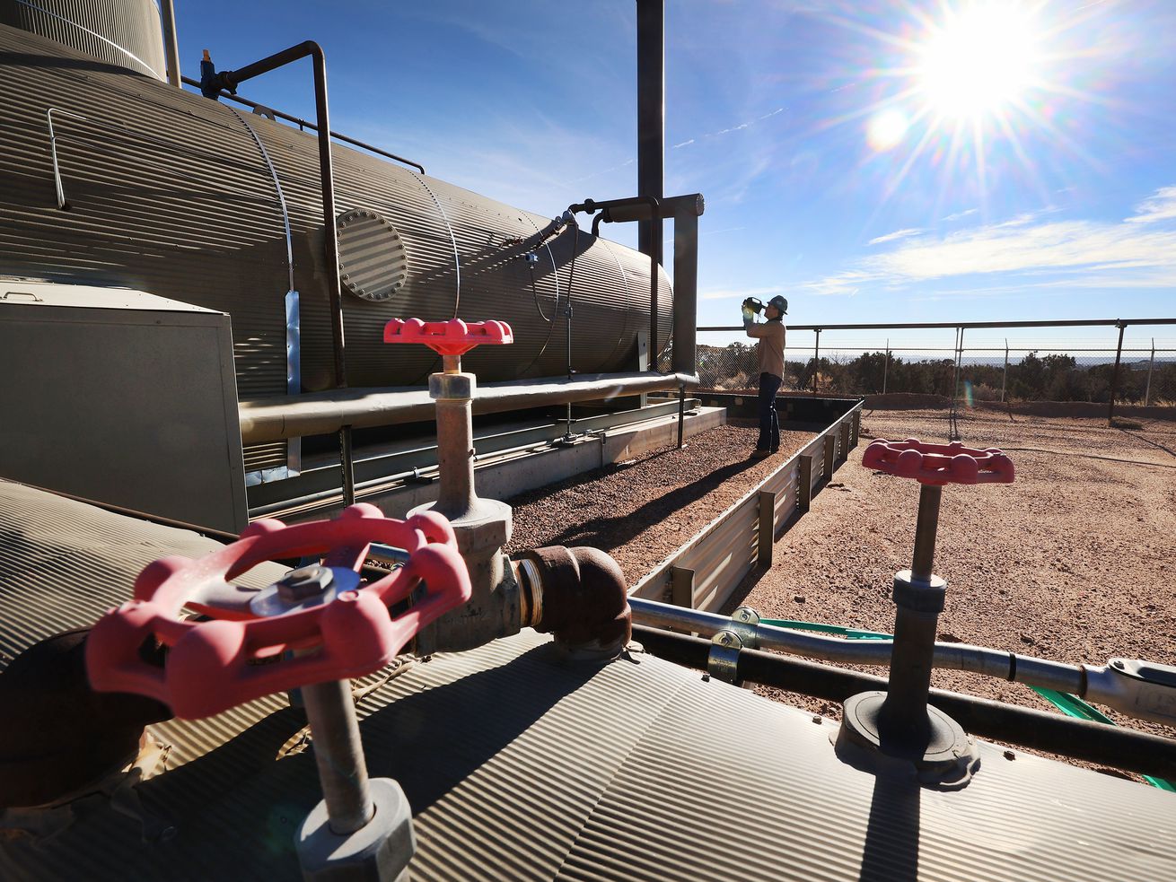 Stephen Foulger, an environmental scientist with the Utah Department of Environmental Quality, uses a Flir gas detection camera during an inspection of an oil pump site near Roosevelt on Dec. 1, 2021.