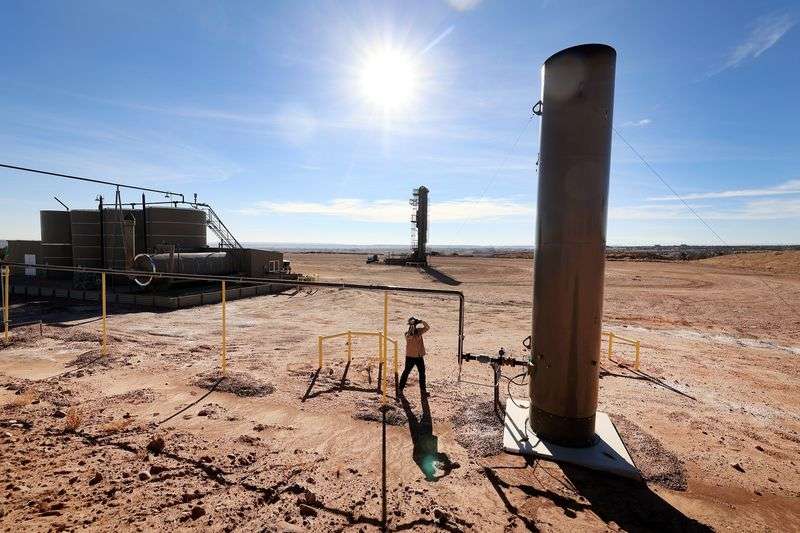 Stephen Foulger, an environmental scientist with the
Utah Department of Environmental Quality, uses a Flir gas detection
camera during an inspection of an oil pump site near Roosevelt on
Wednesday, Dec. 1, 2021.