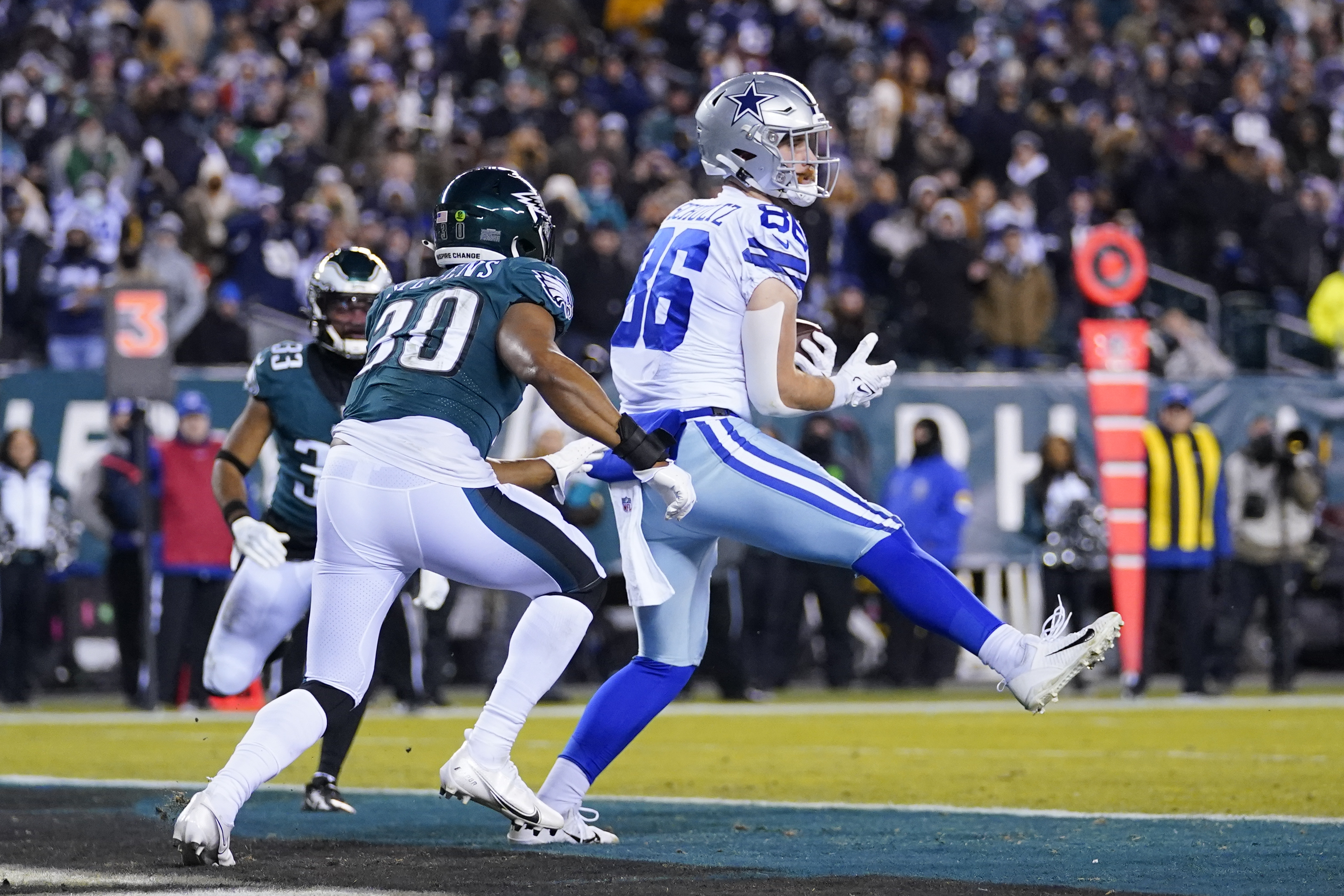 Dallas Cowboys tight end Dalton Schultz, right, catches a touchdown pass over Philadelphia Eagles linebacker JaCoby Stevens, left, during the first half of an NFL football game, Saturday, Jan. 8, 2022, in Philadelphia.