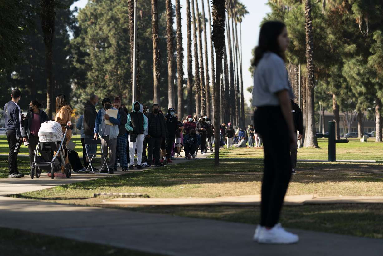 People wait in line for a rapid antigen test at a COVID-19 testing site in Long Beach, Calif., Thursday, Jan. 6.