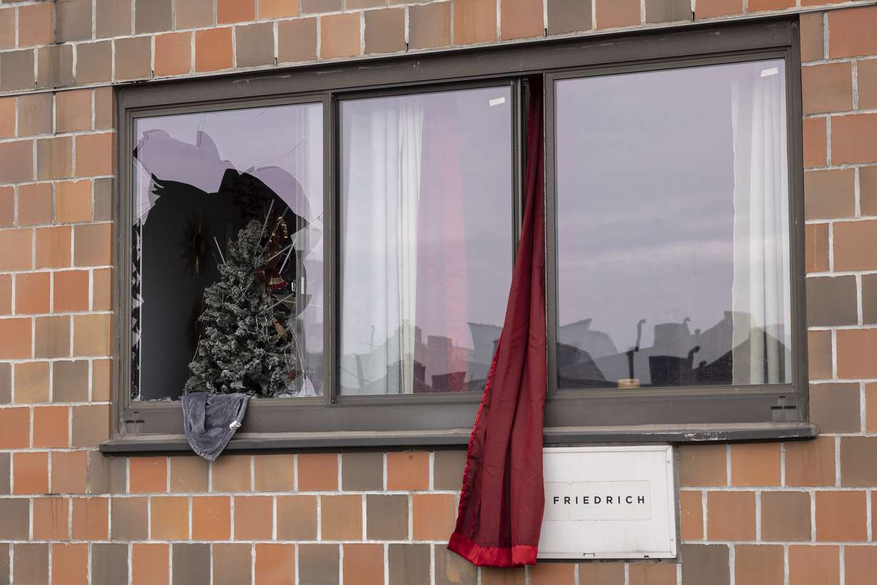 A curtain hangs outside a window at an apartment building in the Bronx on Sunday, in New York, where a fatal fire occurred, in what the city's fire commissioner called one of the worst blazes in recent memory.