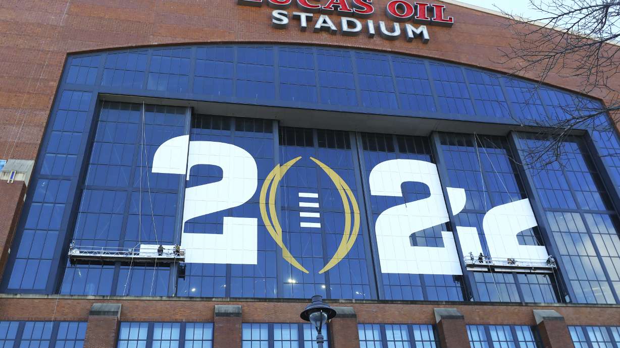 Workers put the final touches on Lucas Oil Stadium ahead of the NCAA college football national championship game between Alabama and Georgia on Friday, Jan. 7, 2022, in Indianapolis.