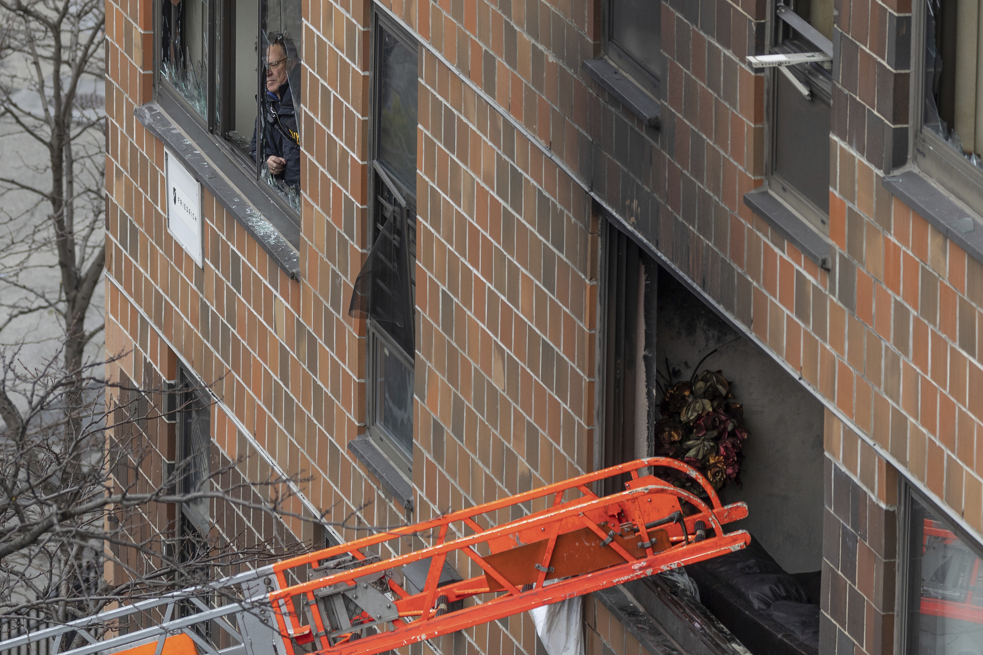 A ladder leads up to a window after a fatal fire at an apartment building in the Bronx on Sunday, in New York. The majority of victims were suffering from severe smoke inhalation, FDNY Commissioner Daniel Nigro said.