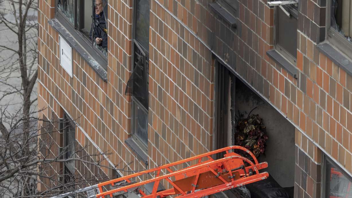 A ladder leads up to a window after a fatal fire at an apartment building in the Bronx on Sunday, in New York. The majority of victims were suffering from severe smoke inhalation, FDNY Commissioner Daniel Nigro said.