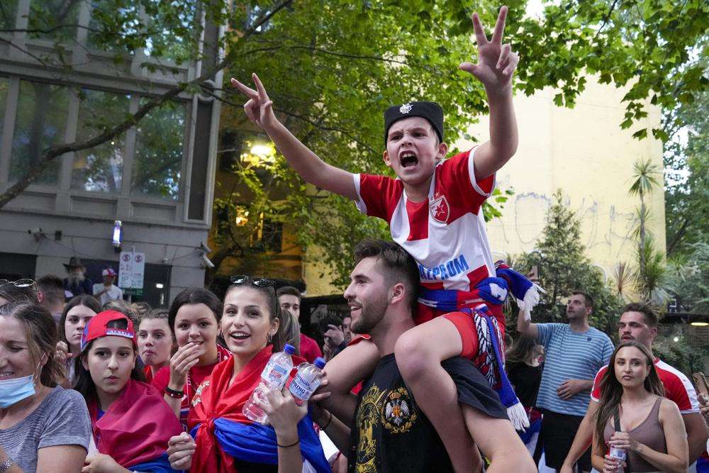 Fans cheer outside an immigration detention hotel where Serbian tennis star Novak Djokovic is confined in Melbourne, Australia, Monday.