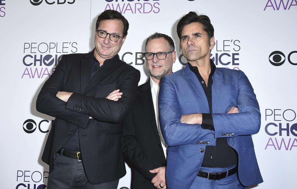 Bob Saget, from left, Dave Coulier and John Stamos, winners of the award for favorite premium comedy series for "Fuller House," pose in the press room at the People's Choice Awards at the Microsoft Theater on Wednesday, Jan. 18, 2017, in Los Angeles.