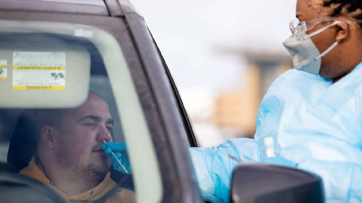 Gabriel Rosito gets a COVID-19 test administered by health care worker Miracle Wright at City Hall in Herriman on Thursday, Jan. 6. Utah health officials reported a record 9,813 new COVID-19 cases on Tuesday, as well as 15 deaths.