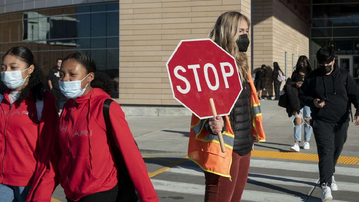 Students at Mount Jordan Middle School in Sandy wear
masks on their way to school on Monday as Salt Lake
County has issued a 30-day mask order.