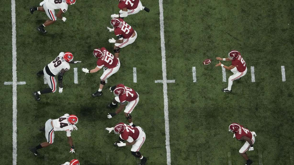 Alabama's Bryce Young takes a snap during the first half of the College Football Playoff championship football game against Georgia Monday, Jan. 10, 2022, in Indianapolis.