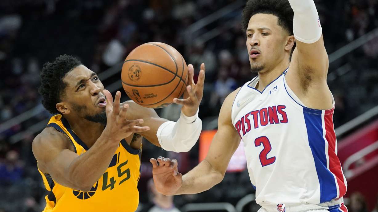 Utah Jazz guard Donovan Mitchell (45) looses control of the ball as Detroit Pistons guard Cade Cunningham (2) defends during the second half of an NBA basketball game, Monday, Jan. 10, 2022, in Detroit.