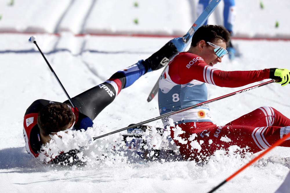 Russia's Alexander Terentev, right, and Czech Republic's Michal Novak, left, crash during a men's cross country sprint quarter final race at the FIS Nordic World Ski Championships in Oberstdorf, Germany, Feb. 25, 2021.