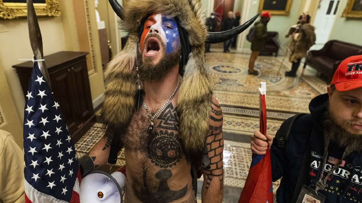 Jacob Anthony Chansley, center, with other insurrectionists who supported then-President Donald Trump, are
confronted by U.S. Capitol Police in the hallway outside of the Senate chamber in the Capitol, Jan. 6, 2021, in Washington.
Chansley was among the first group of insurrectionists who entered the hallway outside the Senate chamber.