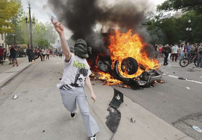A protester throws a water bottle at police in Salt Lake City on May 30, 2020. Protesters joined others across the nation to decry the death of George Floyd, a Black man, who died while being taken into custody by police in Minneapolis earlier this week.