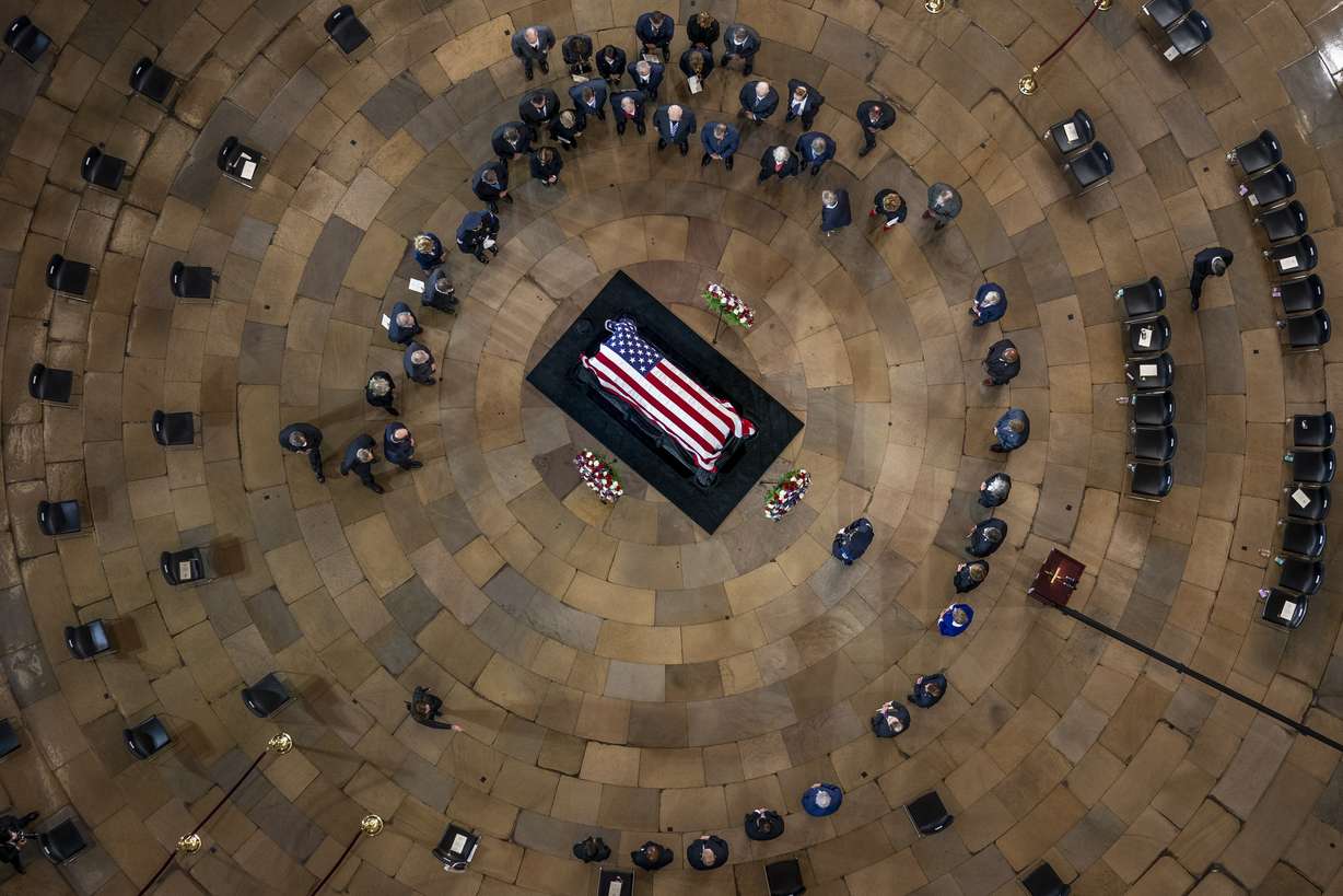 Members of Congress surround the casket of former Sen. Harry Reid, D-Nev., as he lies in state in the Rotunda of the U.S. Capitol, Wednesday, in Washington.
