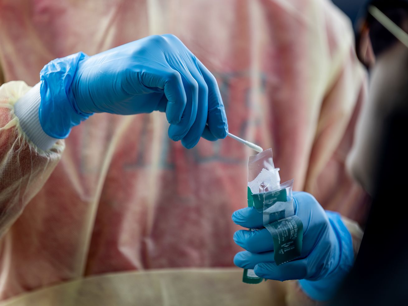Health care worker Bob Ekoh administers a COVID-19 test at City Hall in Herriman on Jan. 6.