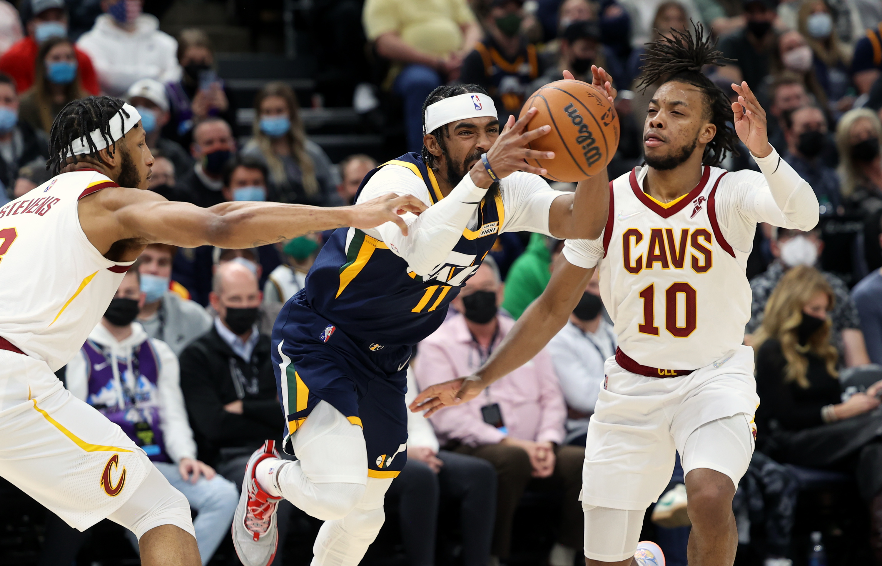 Cleveland Cavaliers forward Lamar Stevens (8) grabs Utah Jazz guard Mike Conley (11) for a no call as the Utah Jazz and the Cleveland Cavaliers play an NBA basketball game at Vivint Arena in Salt Lake City on Wednesday, Jan. 12, 2022.