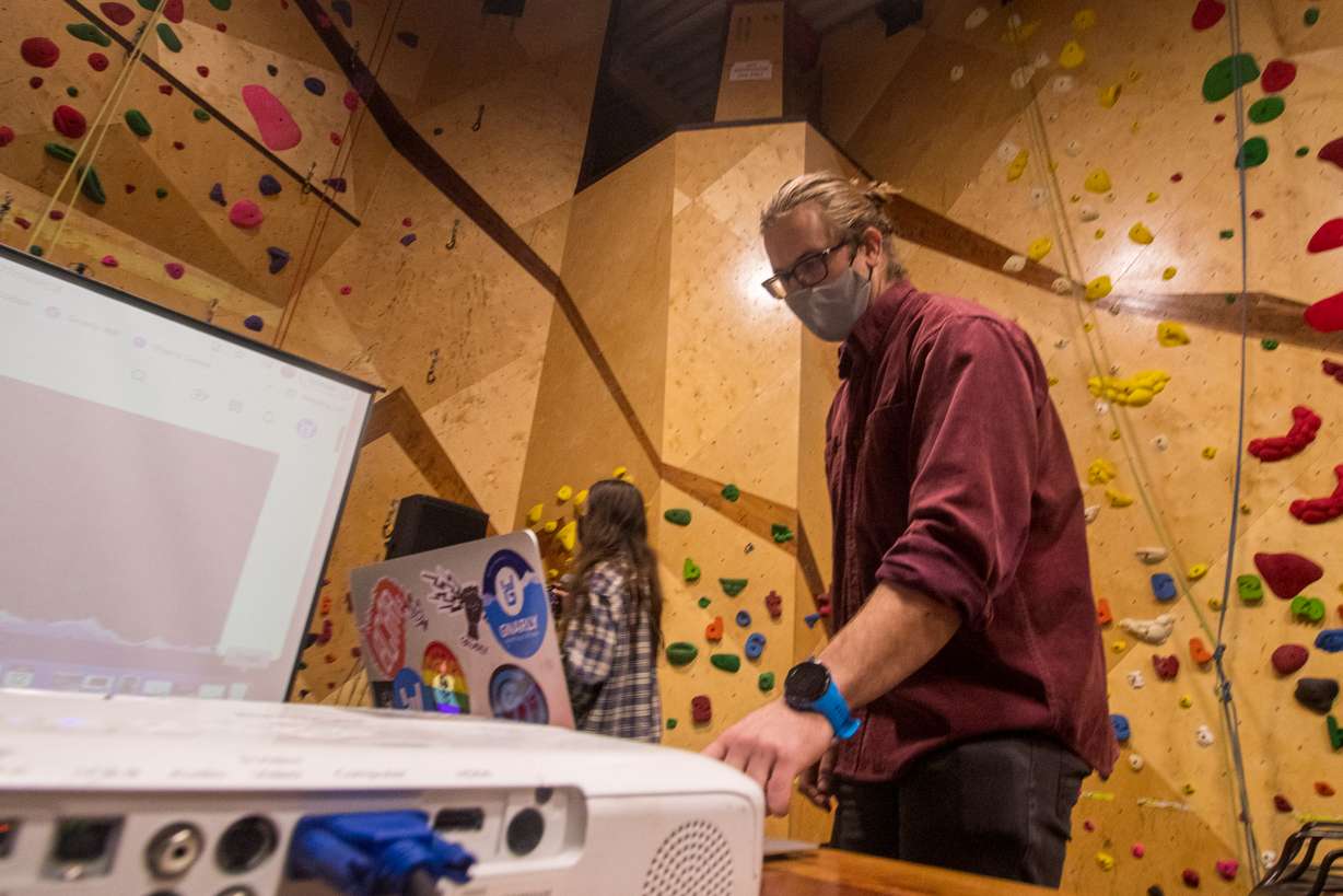 Tim Behuniak, a content manager for Salt Lake City-based company Gnarly Nutrition, sets up "Home Crag" during a debut viewing at The Front Climbing Club in Salt Lake City on Wednesday night.