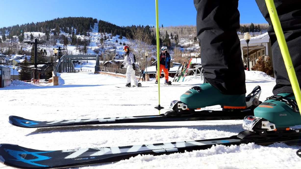Skiers and snowboarders move to get on a lift in Park
City on Jan. 11. Vail Resorts is raising its minimum wage to $20 per hour.