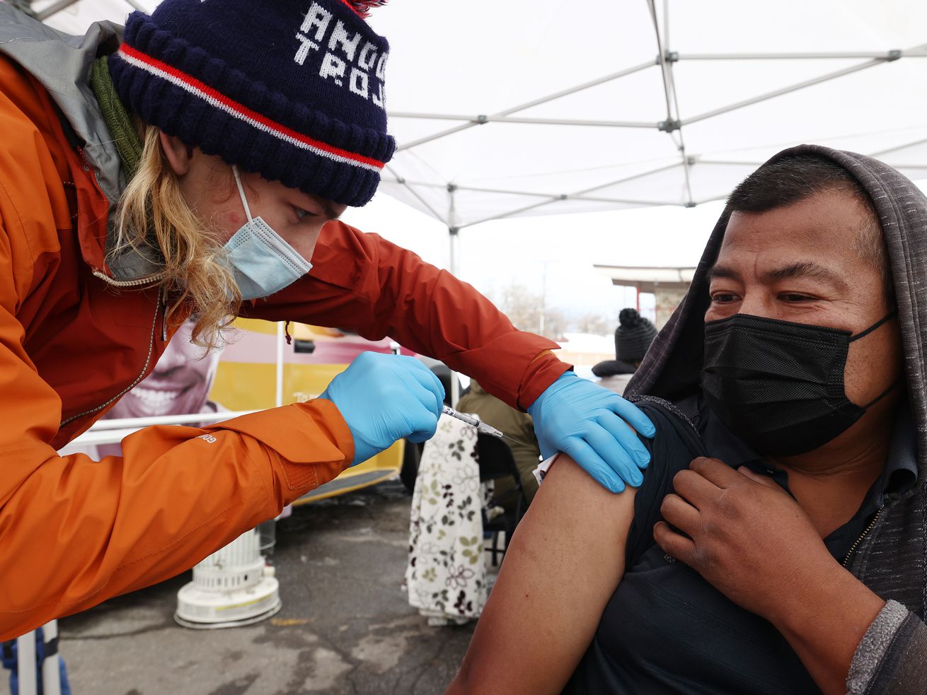 Tristin Torkelson, an EMT with Salt Lake County, gives Raymundo Altamirano a COVID-19 vaccination at a Salt Lake County
Health Department mobile site at Tejeda’s Market in Salt Lake City on Dec. 29, 2021.