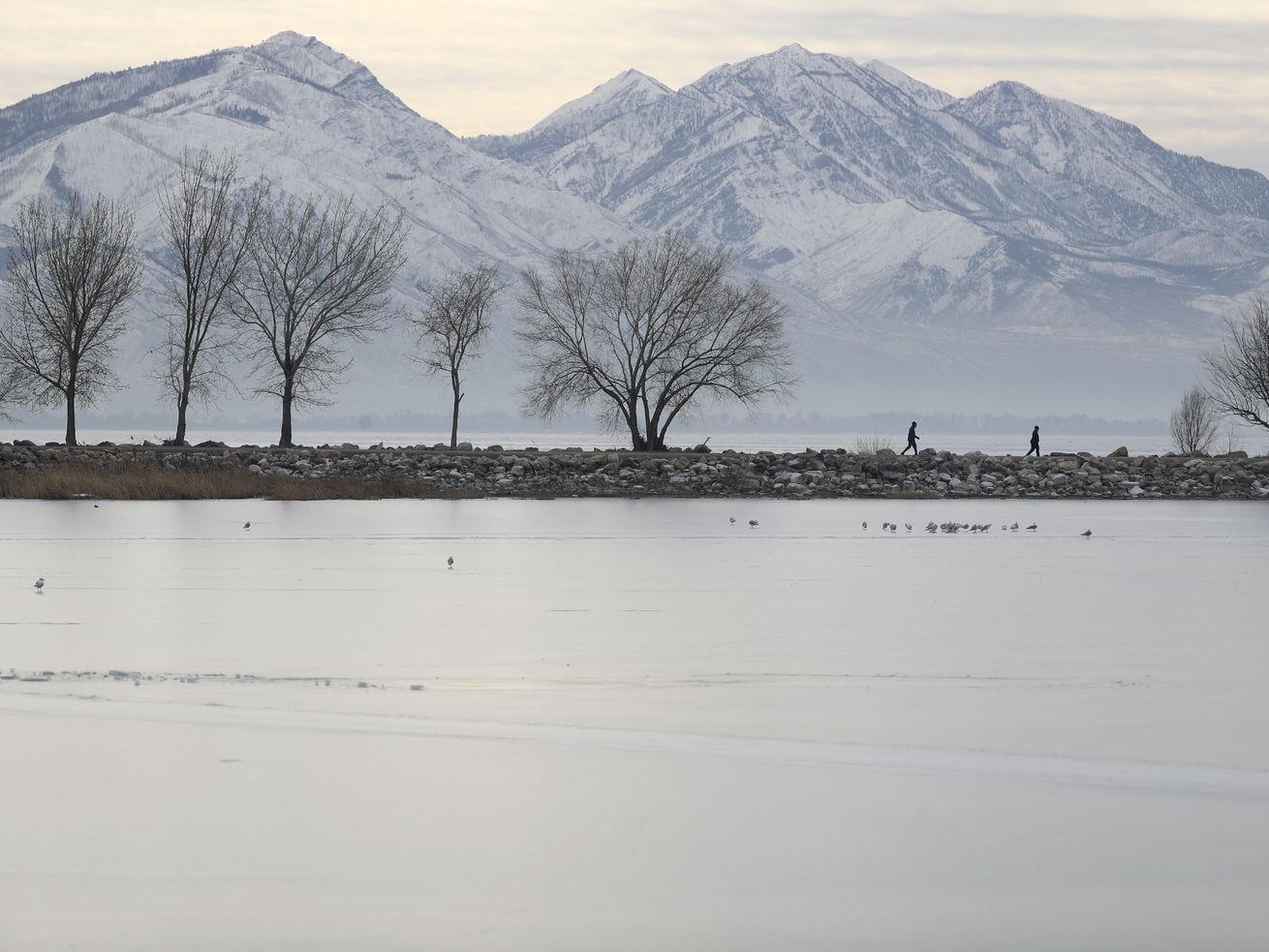 People walk on a jetty in Utah Lake State Park in Provo
on Thursday. Stakeholders gathered at Utah
Valley University this week to discuss the future of the lake,
including scientists, lawmakers, government officials and the
public.