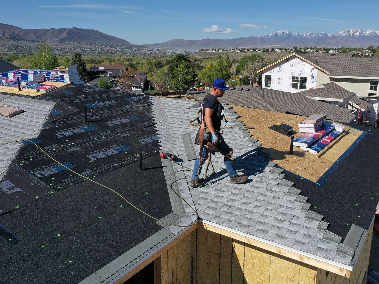 Robert Zavala roofs a home under construction in Sandy on Wednesday, May 5, 2021. A recent report says homebuyers need to earn over $100,000 a year in order to afford Salt Lake County’s median-priced homes, estimated at $460,000.