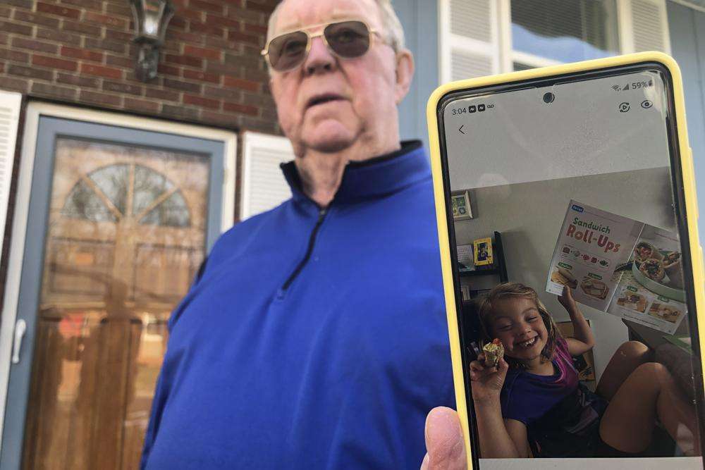 Retiree Andy Roberts displays a photo of his daughter, 5-year-old Tesla, at his home Thursday, in St. Albans, W.Va. Roberts relied on the check to help raise his two young grandchildren, whom he and his wife adopted.