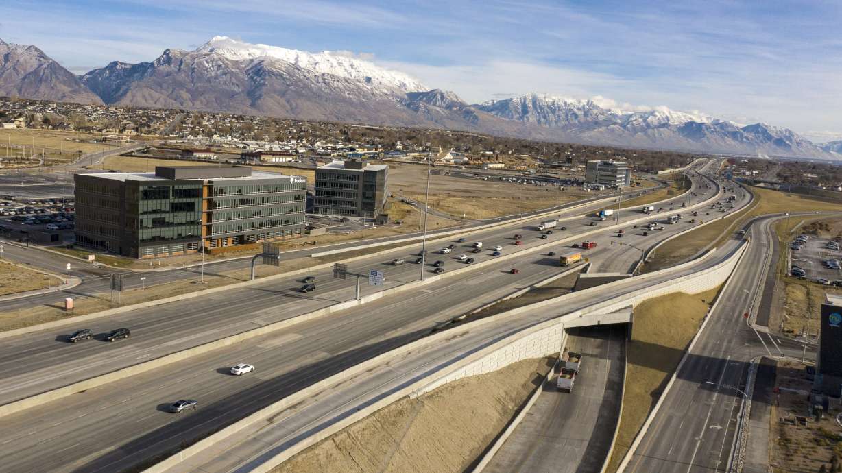 Traffic moves along I-15 in Lehi on Dec. 16, 2020. The Utah Department of Transportation says 23 more light poles are being removed starting this weekend after one of the 120-foot fell last month and four more were found to be unstable.