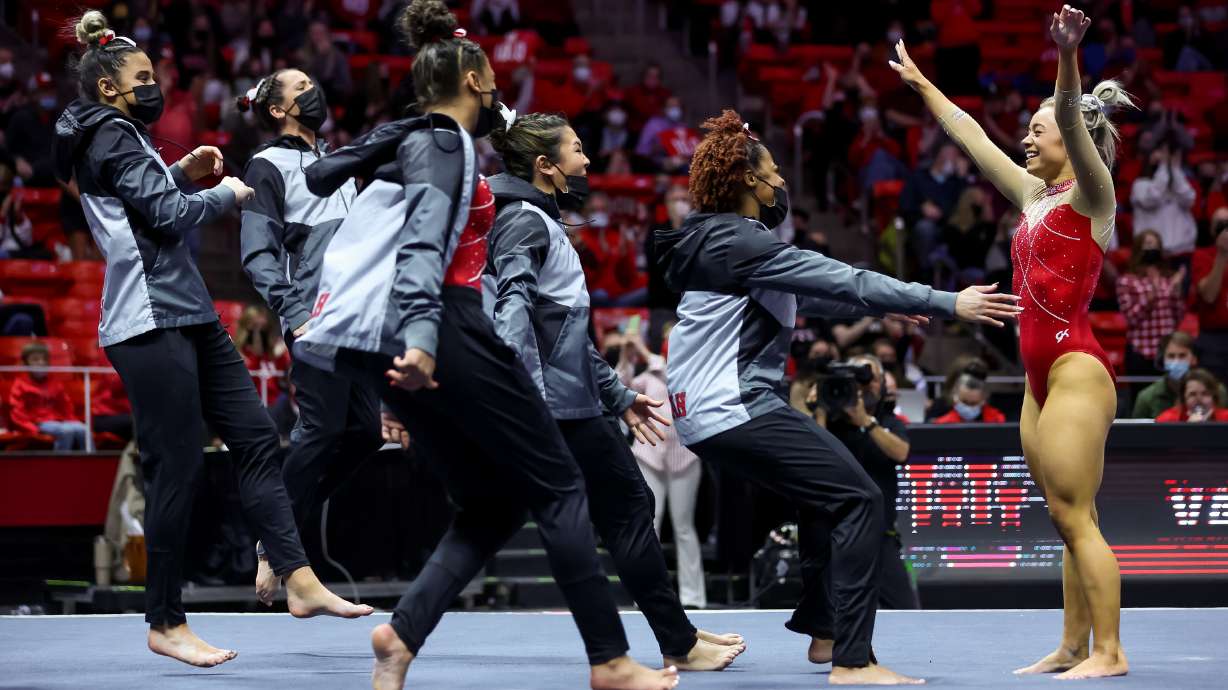 Utah’s Sydney Soloski gets congratulated by teammates after her floor routine during the gymnastics meet with Oklahoma at the Huntsman Center in Salt Lake City on Friday, Jan. 14, 2022.